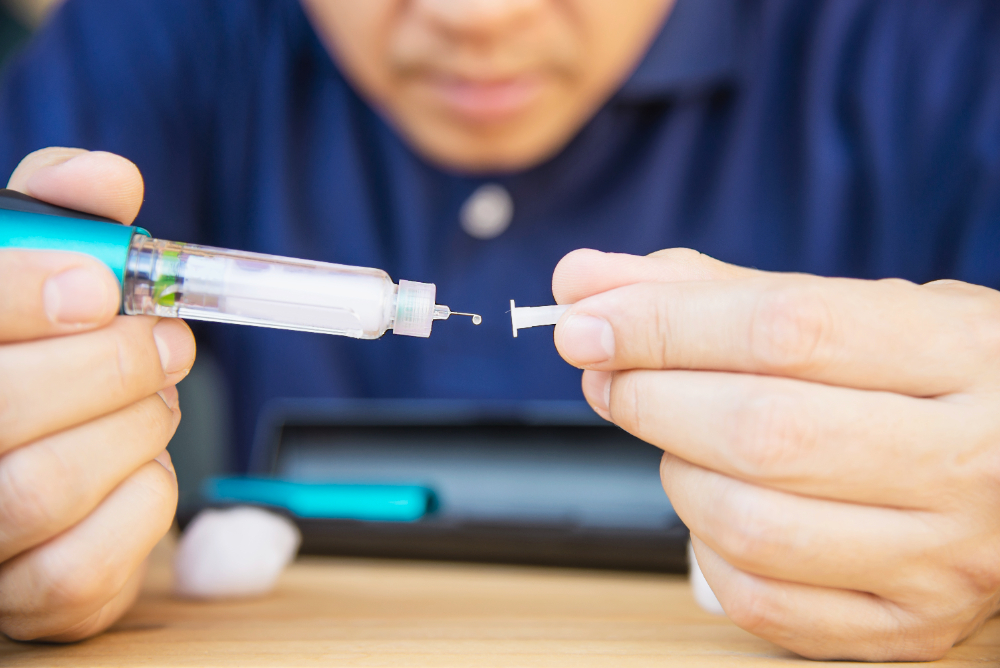 Man preparing ozempic syringe to administer for belly weight loss.